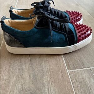 Christian Louboutin teal sneakers with red spikes. In good used condition. 40.5